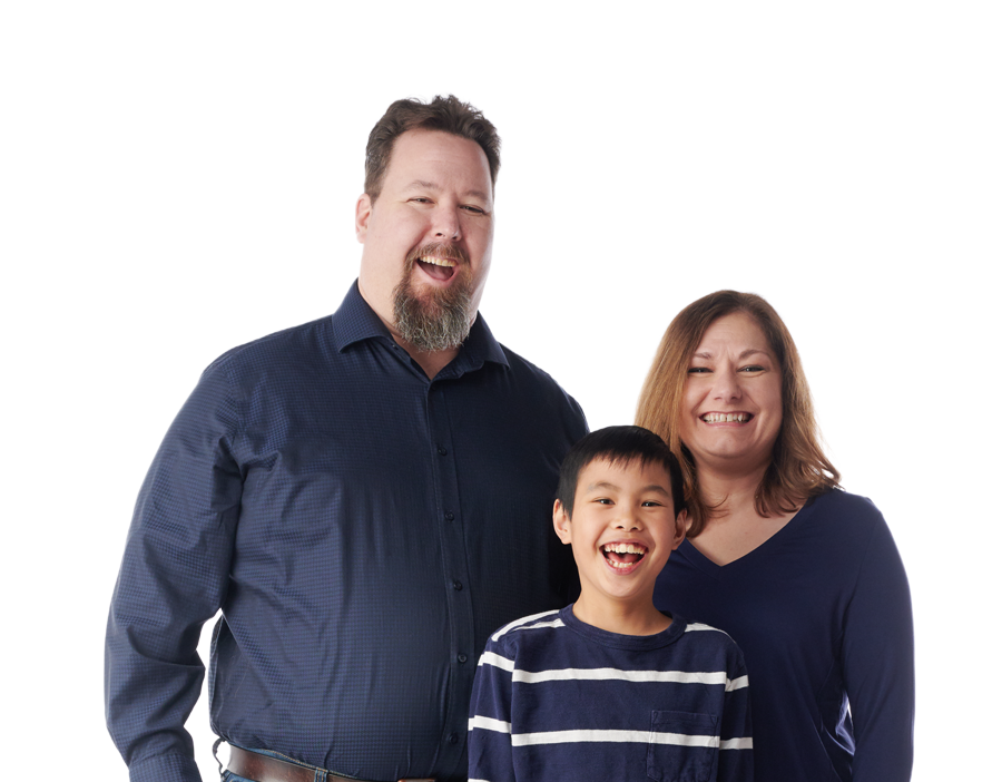 Portrait of a family of three looking at the camera