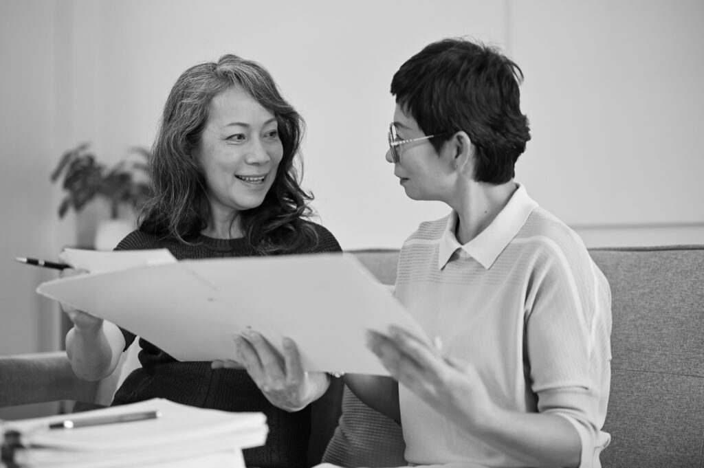 Senior couple hugging and smiling looking at a document on a table