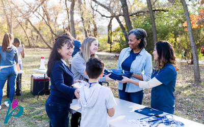 Two people at a booth for Parkinson Society BC